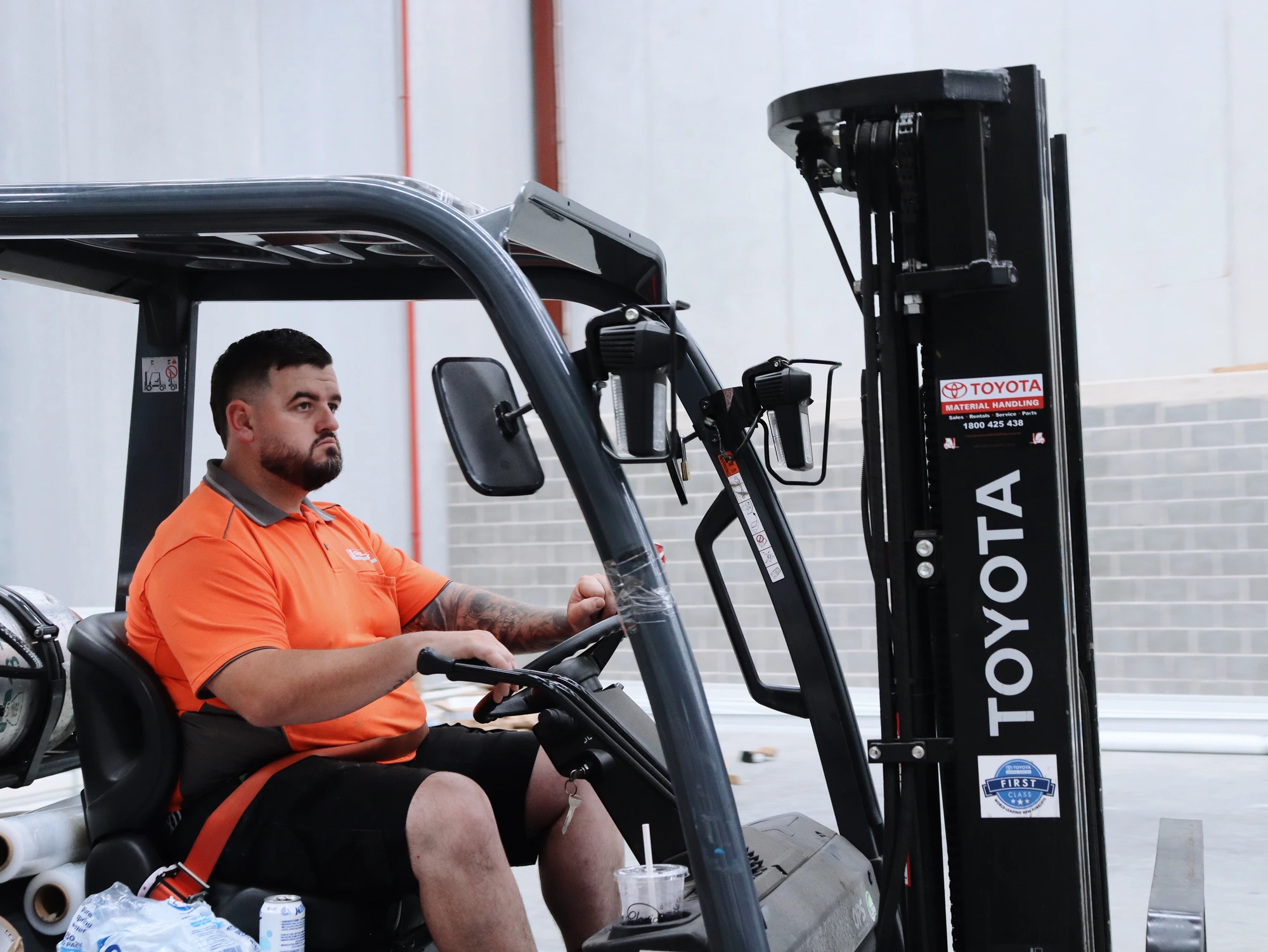Select Coolrooms installer at the controls of the forklift inside the Chullora warehouse on day one