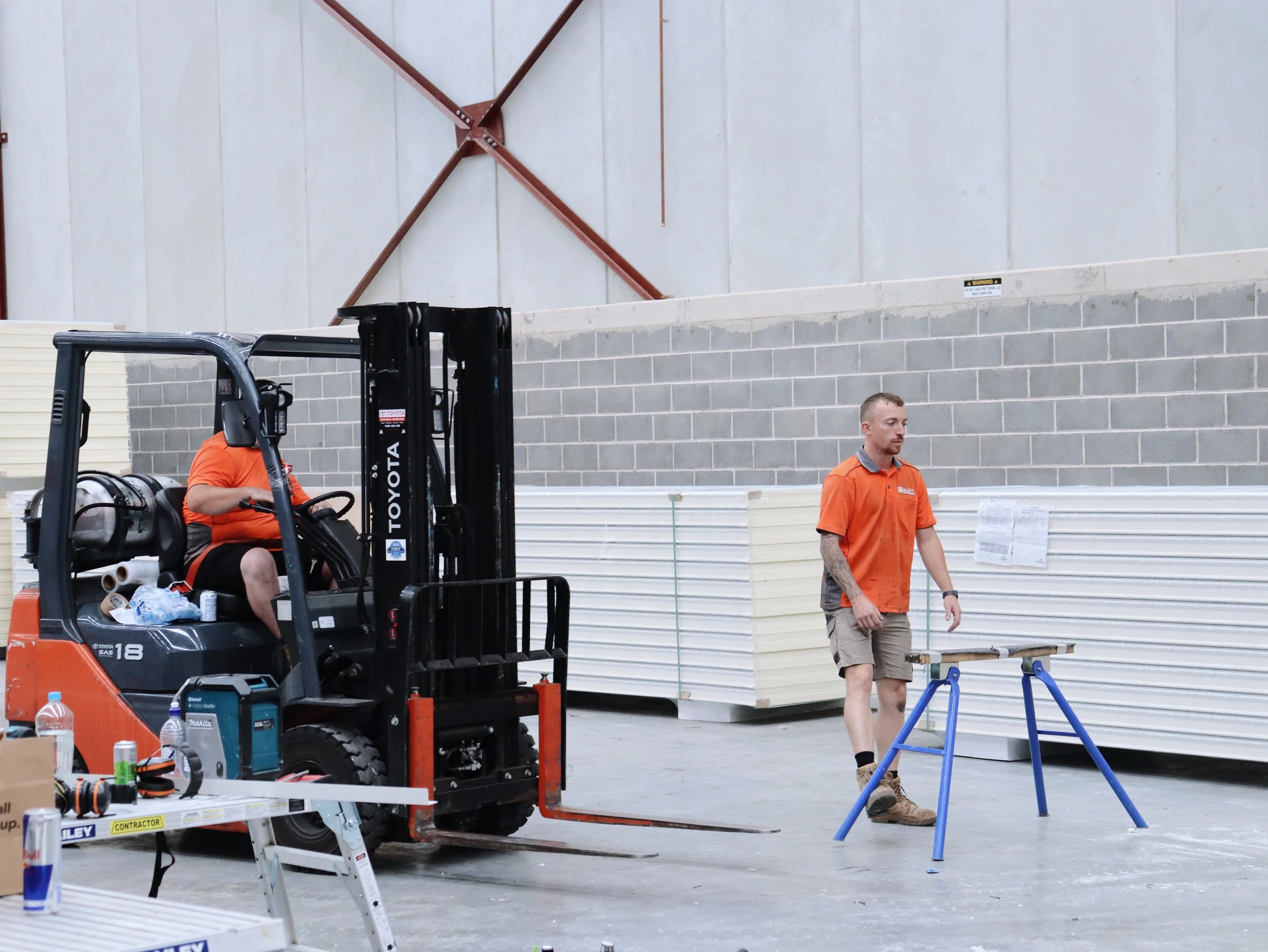 Select Coolrooms forklift and installer staging insulated panels on trestles at Chullora