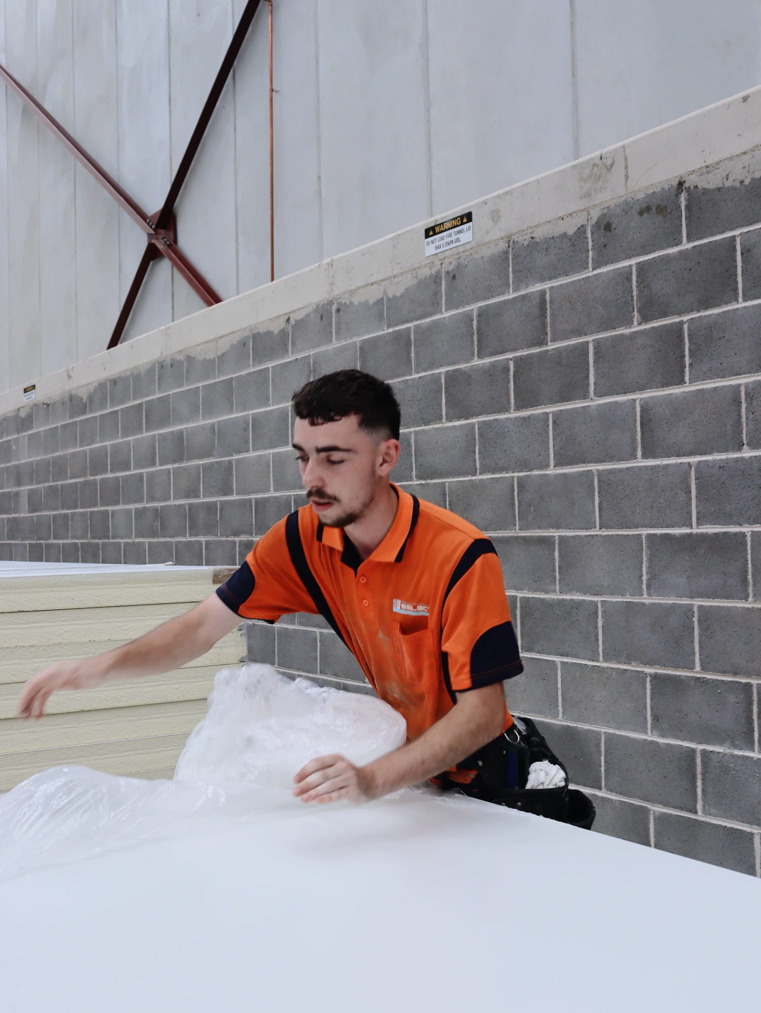 Protective wrapping coming off the next insulated panel at the Chullora build