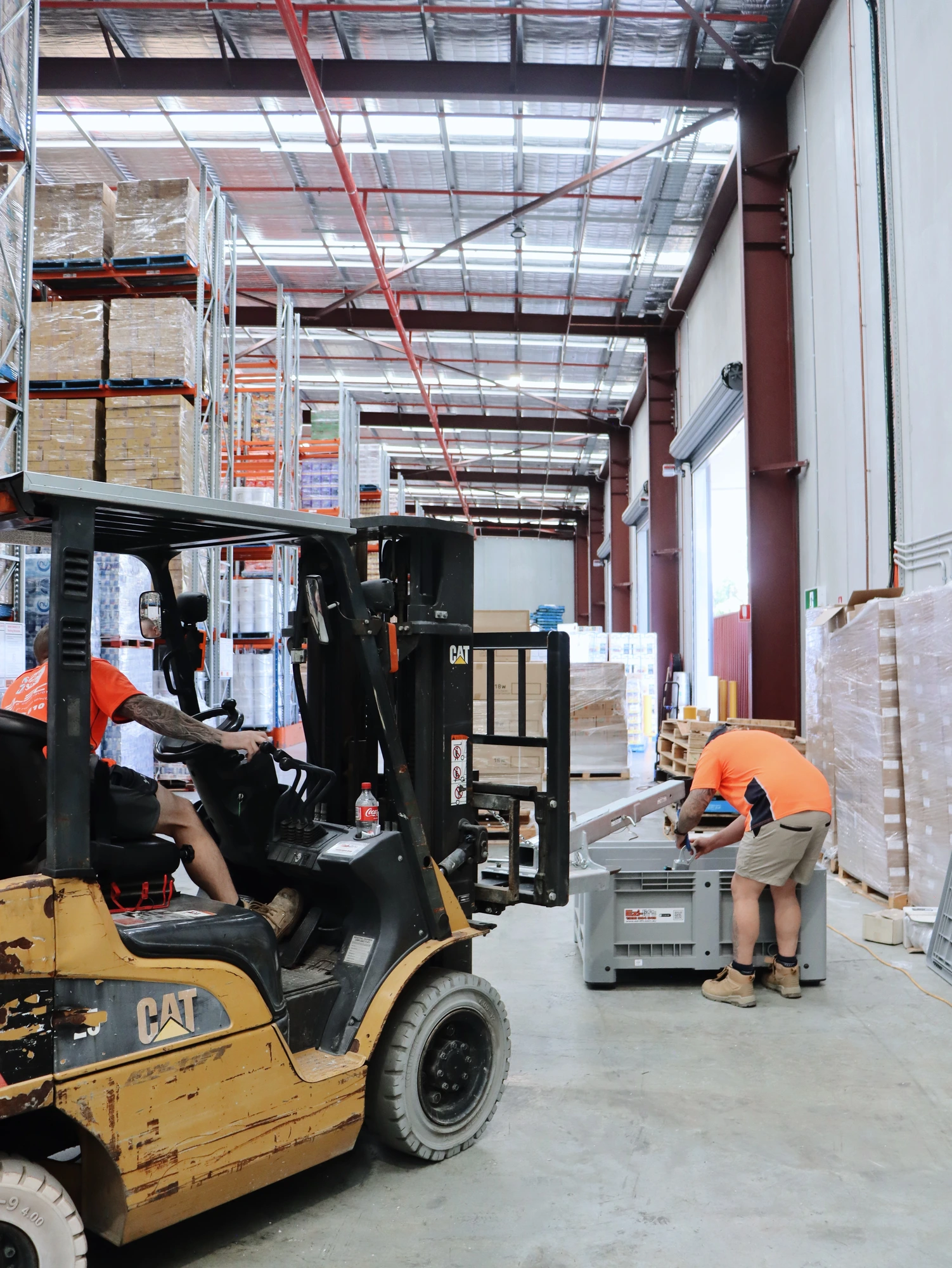 Select Coolrooms crew working alongside the client's forklift and racked stock at Chullora