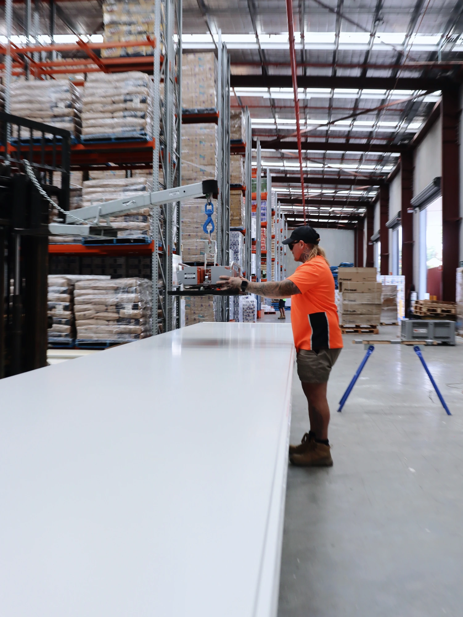 Positioning the lifting attachment over a full length insulated panel at Chullora